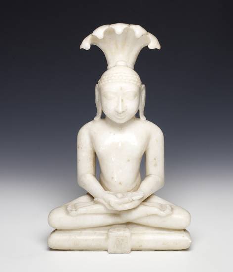 A 19th-century figure of the 23rd Jina Pārśvanātha or Lord Pārśva. He is believed to have given Jains four fundamental vows to help them towards liberation, to which his successor Mahāvīra added another. This white marble image of Pārśva shows the Jina si
