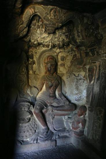 Ninth-century image of the goddess Ambikā at Ellora, Maharashtra, one of the oldest surviving figures of this deity. The boy with whom Ambikā is often portrayed sits slightly in front of her and a lion – her divine vehicle – is on her right.