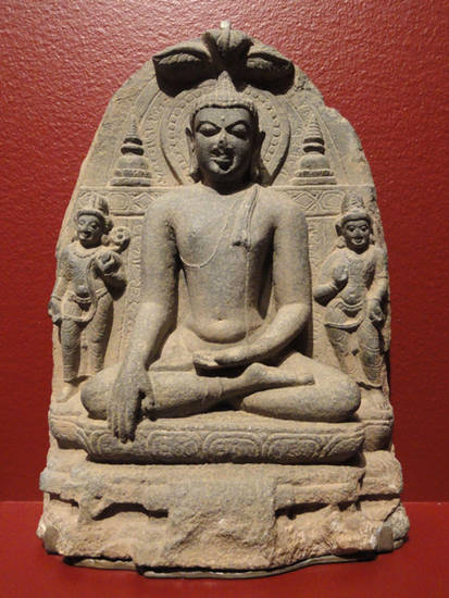 This stone sculpture of Buddha dates from the tenth century. Called 'Buddha' – 'Awakened One' – after he reached enlightenment, the life of Prince Siddhartha Gautama is similar to that of the Jinas. Art of Buddha and the Jinas is often very similar
