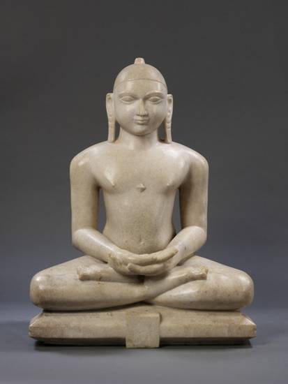 This 19th-century idol from Jaipur, Rajasthan, is of Candraprabha, the eighth Jina. This typical Digambara image shows the plainly sculpted Jina nude with closed eyes. He wears a small cap but his emblem of the crescent moon is missing