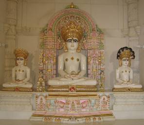 Idols of Ṛṣabha, Māhavīra and Pārśva, in the Śvetāmbara temple in Potters Bar, England. The last of the 24 Jinas, Māhavīra, is in the centre. The first Jina, Ṛṣabha, is on the left while Māhavīra's predecessor, Pārśva, is on the right.