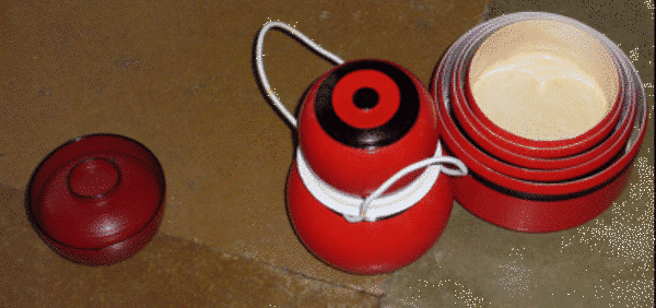 Made of gourds, wood or clay, Śvetāmbara begging bowls – pātra – are usually red or dark orange and are often stacked up inside each other when not being used. String is wound around jars for liquids to create carrying handles.