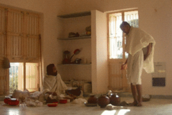 Barefoot and dressed in three simple white garments, Śvetāmbara monks are surrounded by their monastic equipment – upakaraṇa – which consists of brooms, staffs and begging bowls. Every day the monks beg alms from the lay community.