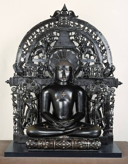 A 12th-century bronze figure of Lord Śānti, the 16th Jina. His deer emblem is on the ornate jewelled cushion while his silver eyes were probably once set with gems and crystal.