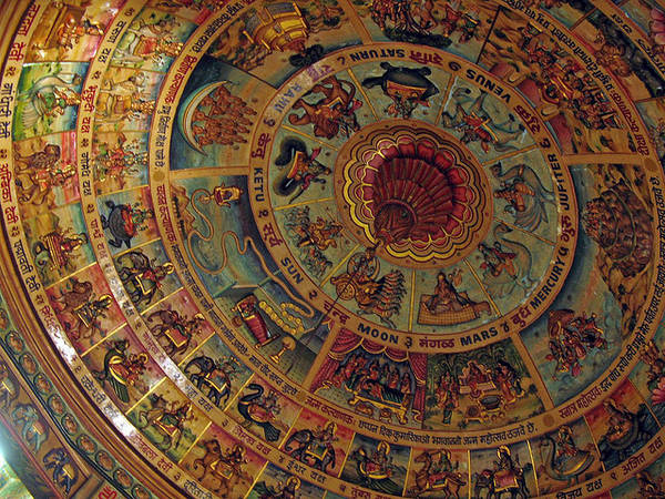 This temple ceiling is painted with the nine celestial entities in the centre of concentric rings featuring various deities and their vehicles, and selected yakṣas and yakṣīs of the Jinas.