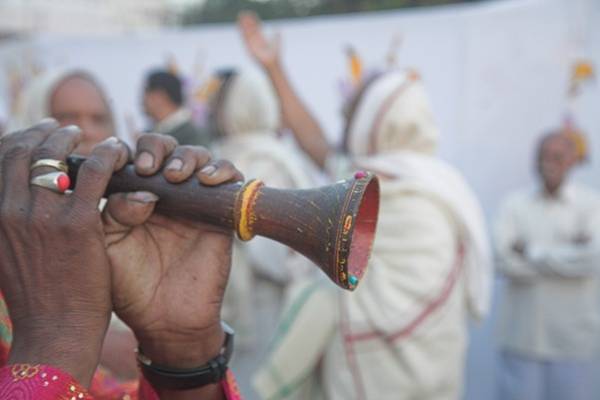 A man plays music after the ordination of a new mendicant while monks, nuns and lay Jains celebrate. The initiation ceremony to become a monk or nun – dīkṣā – is a time of joy, music and festivities for the whole Jain community.
