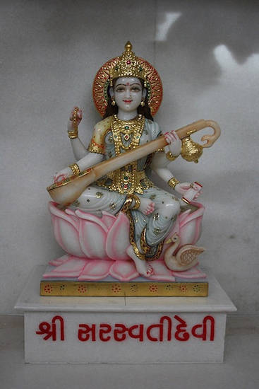 Śvetāmbara figure of the deity Sarasvatī. The goddess of speech and knowledge, Sarasvatī is very popular among Hindus as well as Jains. This colourful statue sits on a lotus, holding her lute – vīṇā – with her divine vehicle of a swan beside her.